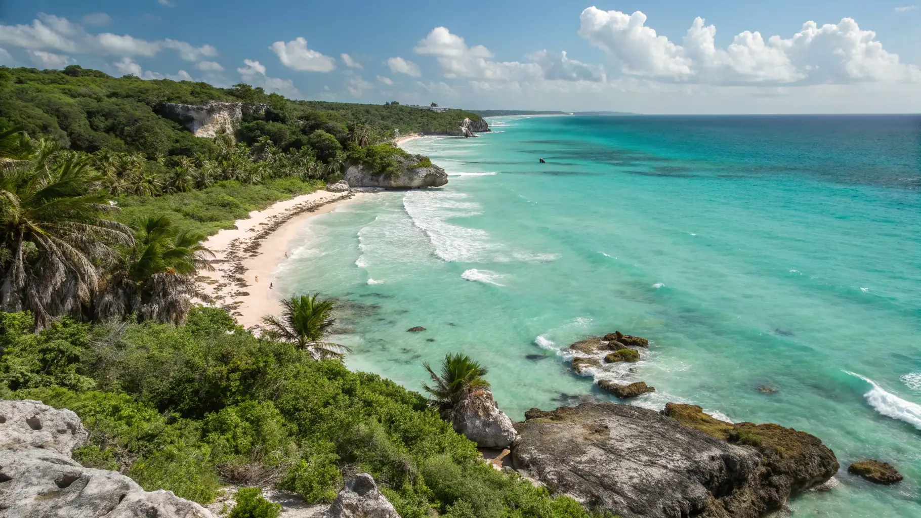 A stunning aerial view of the Riviera Maya coastline, showcasing turquoise waters, white sandy beaches, and lush green jungle. This image represents the beauty and adventure that Xtrem Reboot offers in its pilot region.